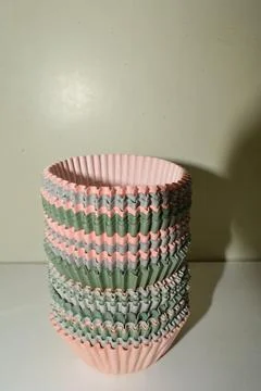 Cups for a muffins on a shelf in the kitchen  Stock Photos