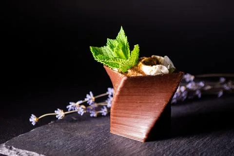 Cups printed on a 3D printer with chocolate, whipped cream and mint leaves Stock Photos