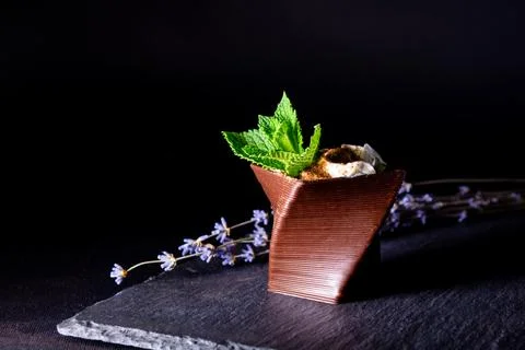 Cups printed on a 3D printer with chocolate, whipped cream and mint leaves Stock Photos