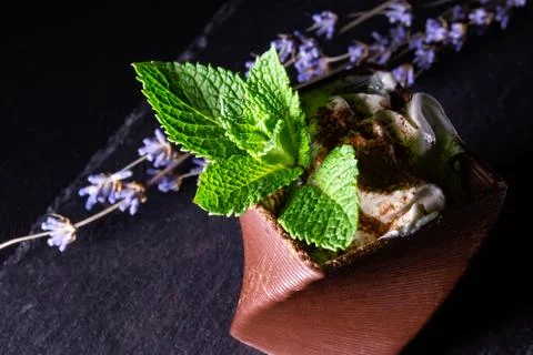 Cups printed on a 3D printer with chocolate, whipped cream and mint leaves Stock Photos