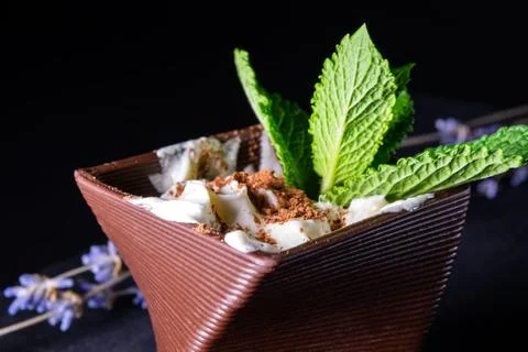Cups printed on a 3D printer with chocolate, whipped cream and mint leaves Stock Photos