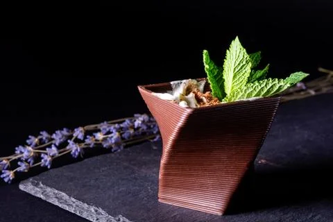 Cups printed on a 3D printer with chocolate, whipped cream and mint leaves Stock Photos