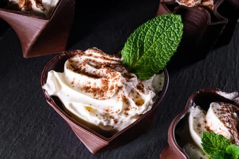 Cups printed on a 3D printer with chocolate, whipped cream and mint leaves Stock Photos