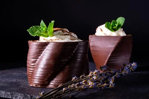 Cups printed on a 3D printer with chocolate, whipped cream and mint leaves Stock Photos