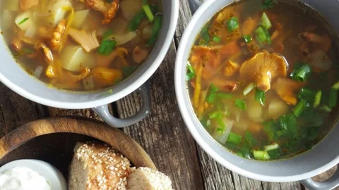 Cups of soup with chanterelles, herbs, breads Stock Footage 159360738