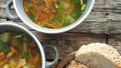 Cups of soup with chanterelles, herbs, breads Stock Footage 159361337