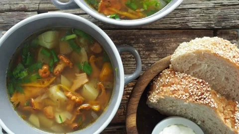 Cups of soup with chanterelles, herbs, breads Stock Footage 159361771