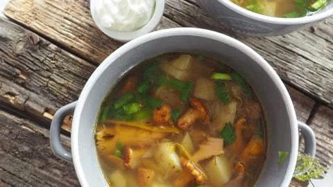 Cups of soup with chanterelles, herbs, breads Stock Footage 159362176