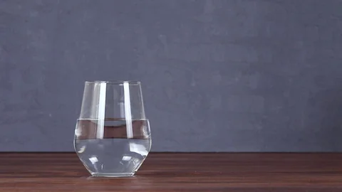 Cups standing at the table are shaking with the effect of earthquake Stock Footage 129614734