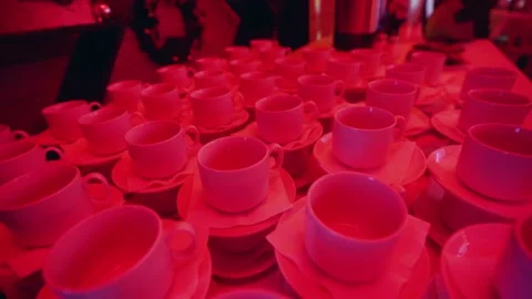Cups on the table illuminated with red light Stock Footage 167791759