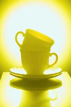 Cups for tea on a yellow background Stock Photos