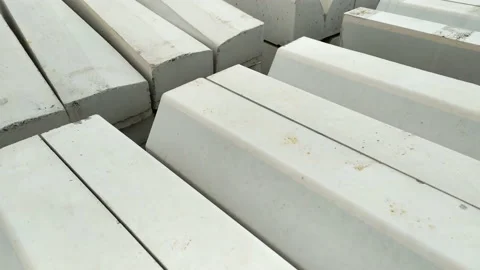 Curb blocks on the construction site of a road. Stack of kerb stones that are Stock Footage 233259094