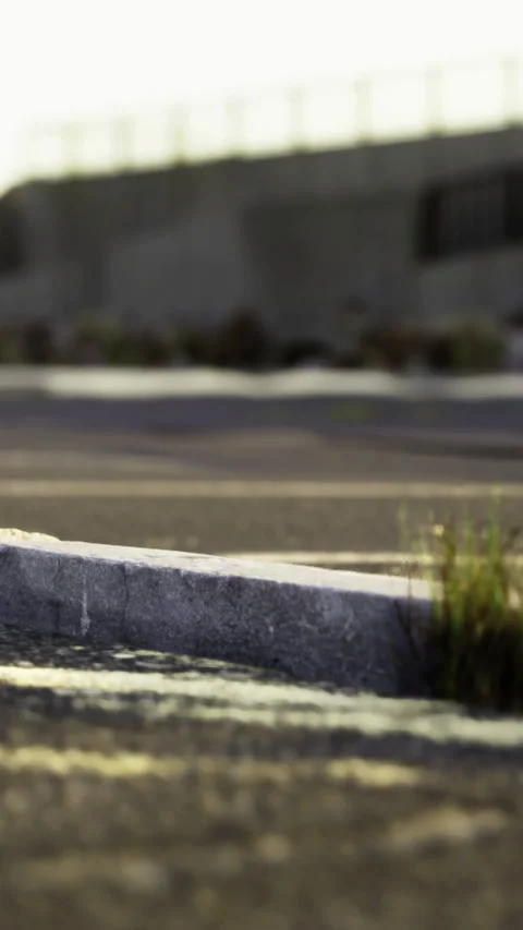 Curb on empty parking lot during sunset near city road Stock-Footage 336582097