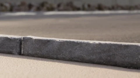 Curb section on a road shows detailed texture and color Stock Footage 344405082