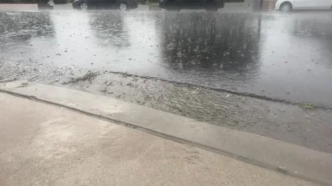 Curb Storm water flowing by Stock Footage 310643541