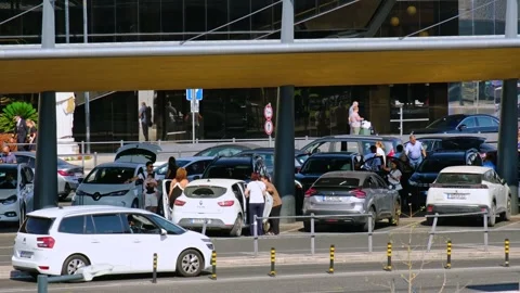 Curbside car queue and passengers at Lisbon airport terminal in Portugal Video stock 342701077