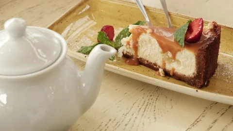 Curd cake with wait and white teapot. Slow motion Video stock 155903291