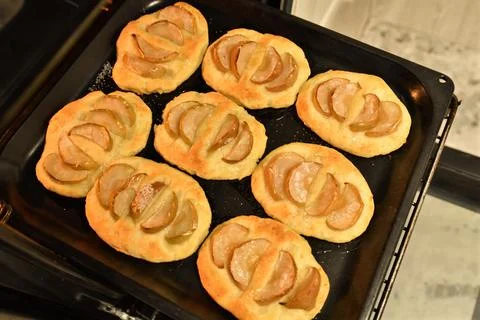 Curd cheesecakes with an apples on a baking sheet Stock Photos
