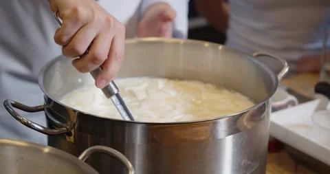 Curdled milk in pan. Cheesemaker making cheese. Stock Footage