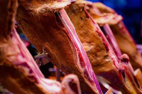 Cured ham legs on display. Stock Photos
