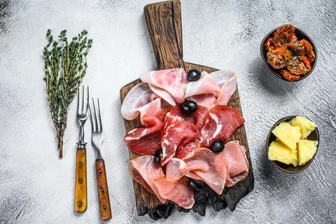Cured meat platter of traditional Spanish tapas. White background. Top view Stock Photos