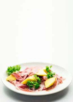 Cured parma serrano style ham with fresh mango salad snack Stock Photos