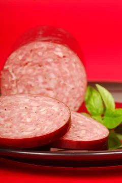 Cured salami with basil Stock Photos
