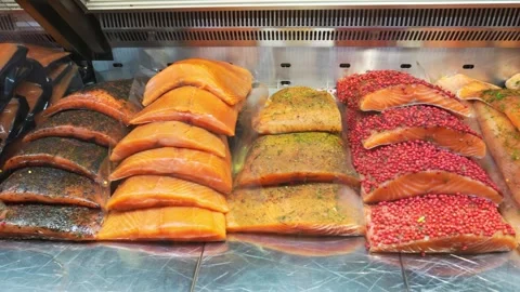 Cured spiced salmon fillets display refrigerated glass counter Helsinki mar.. Stock Footage 341872192