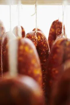 Curing Meat Hanging from Racks Stock Photos