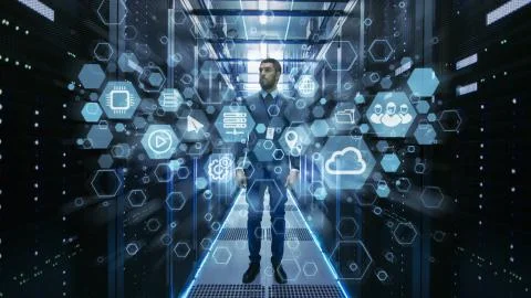 Curios IT Engineer Standing in the Middle of a Working Data Center Server Stock Photos
