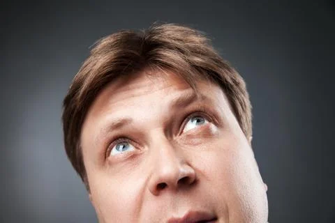 Curious adult man looking up Stock Photos