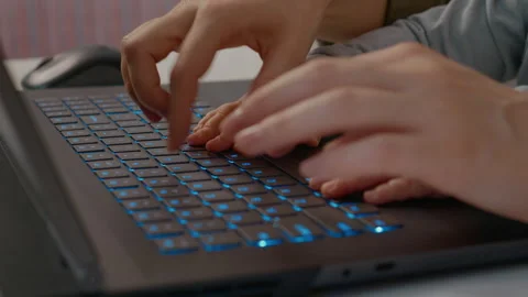 Curious baby explores technology by typing on a laptop keyboard in home office Stock Footage 302912747