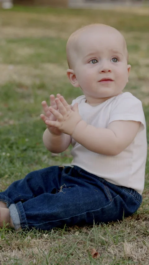 Curious baby exploring nature, touching grass and leaves, discovering textures Stock Footage 318029454