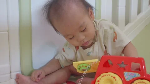Curious Baby Exploring a Toy Vidéo 341142677