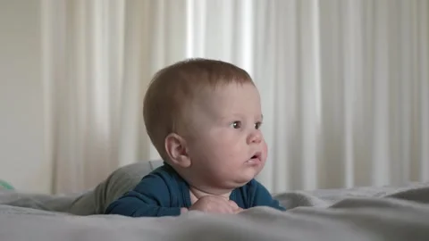 Curious Baby Laying on Bed Stock Footage 292690480
