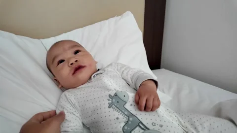 Curious Baby Lying in Bed Stock Footage 313834901