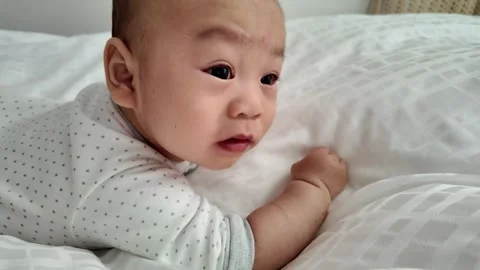 Curious Baby on White Bed Stock Footage 315468985