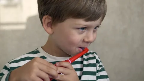 Curious boy activating electric toothbrush and starting gentle brushing, happy Stock Footage 322173145