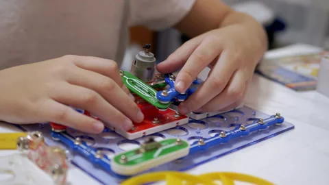 Curious Boy Assembles Electrical Circuit of Metal Construction Kit Parts. Zoom Stock Footage 148239348