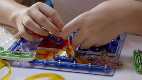 Curious Boy Assembles Electrical Circuit of Metal Construction Kit Parts. Zoom Stock Footage 148241635