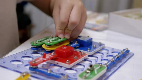 Curious Boy Assembles Electrical Circuit of Metal Construction Kit Parts. Zoom Stock Footage 149892446