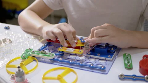 Curious Boy Assembles Electrical Circuit of Metal Construction Kit Parts. 4K Stock Footage 150069711