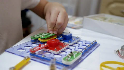 Curious Boy Assembles Electrical Circuit of Metal Construction Kit Parts. 4K Stock Footage 150165255