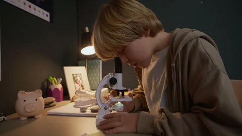 Curious Boy Child Using Microscope at Study Desk at Home Stock Footage 326671259