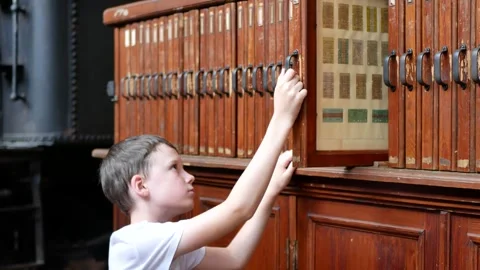 Curious boy exploring vintage train tickets at German Museum of Technology Stock Footage 316179718