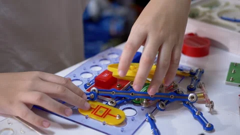 Curious Boy Plays with an Electrical Metal Constructor on Table at Home. 180fps Stock Footage 147453733