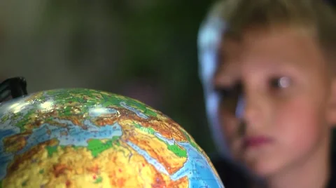 Curious Boy Studying Globe in Classroom Stock Footage 57686052