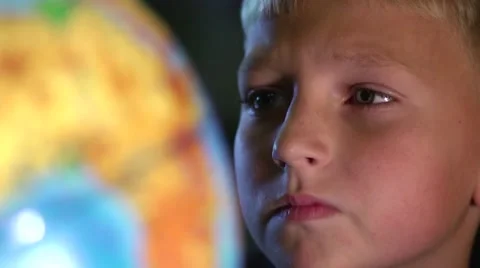 Curious Boy Studying Globe in Classroom Stock Footage 57686068