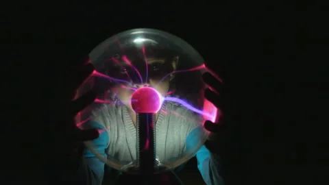 A curious boy is touching the Tesla lamp with his fingers Stock Footage 136366949