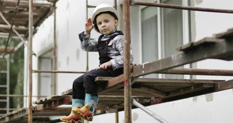 A curious child at a construction site helps his parents. Stock Footage 143559490